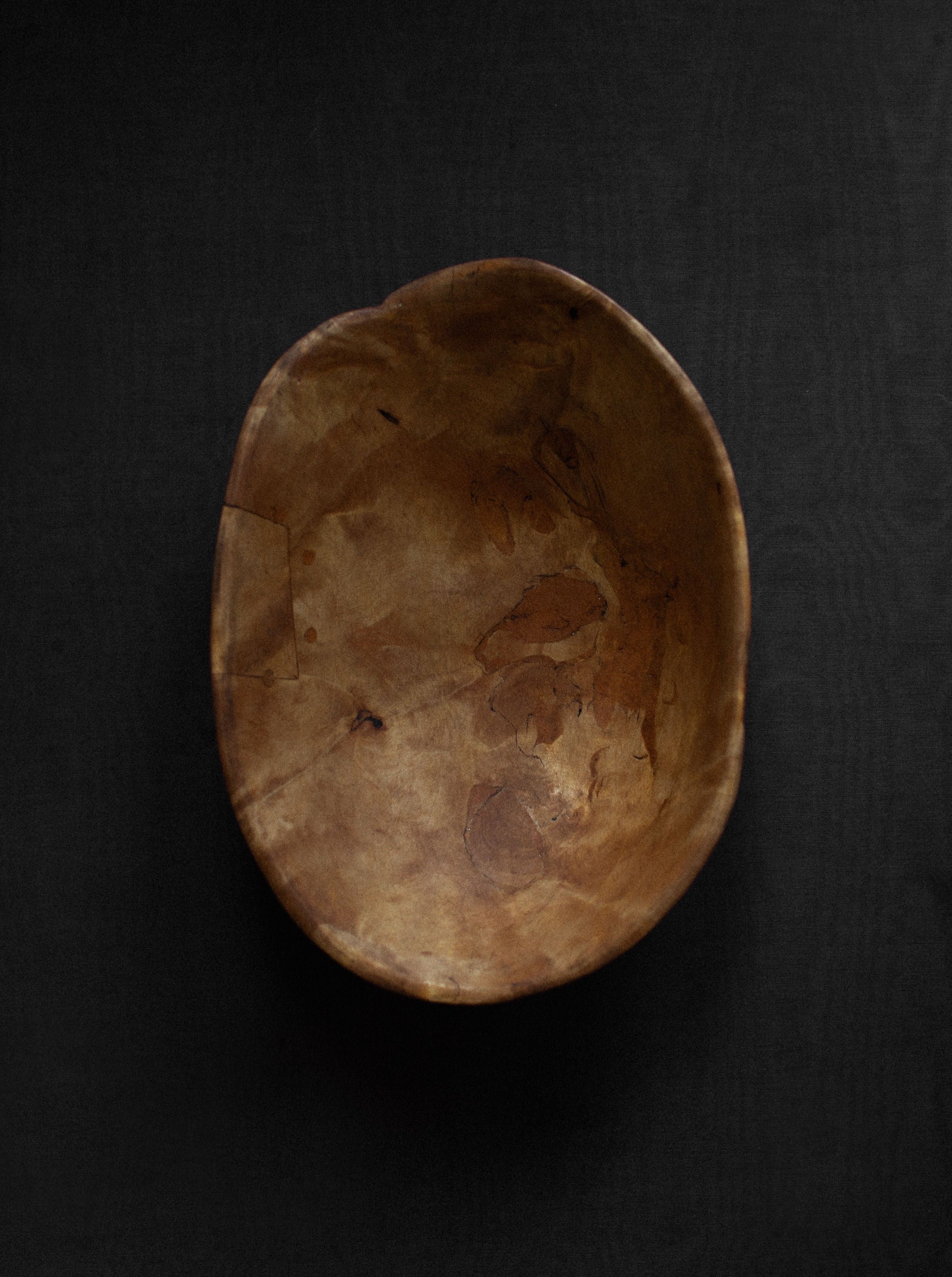 Antique wooden bowl with rich patina and natural imperfections