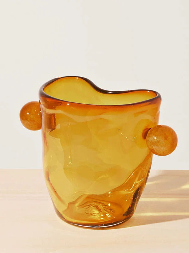 Handmade glass vase featuring a stunning fluted design