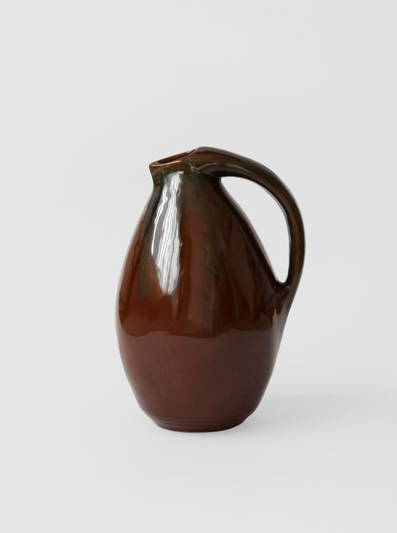 Vintage brown ceramic jug with curved handle and glossy finish