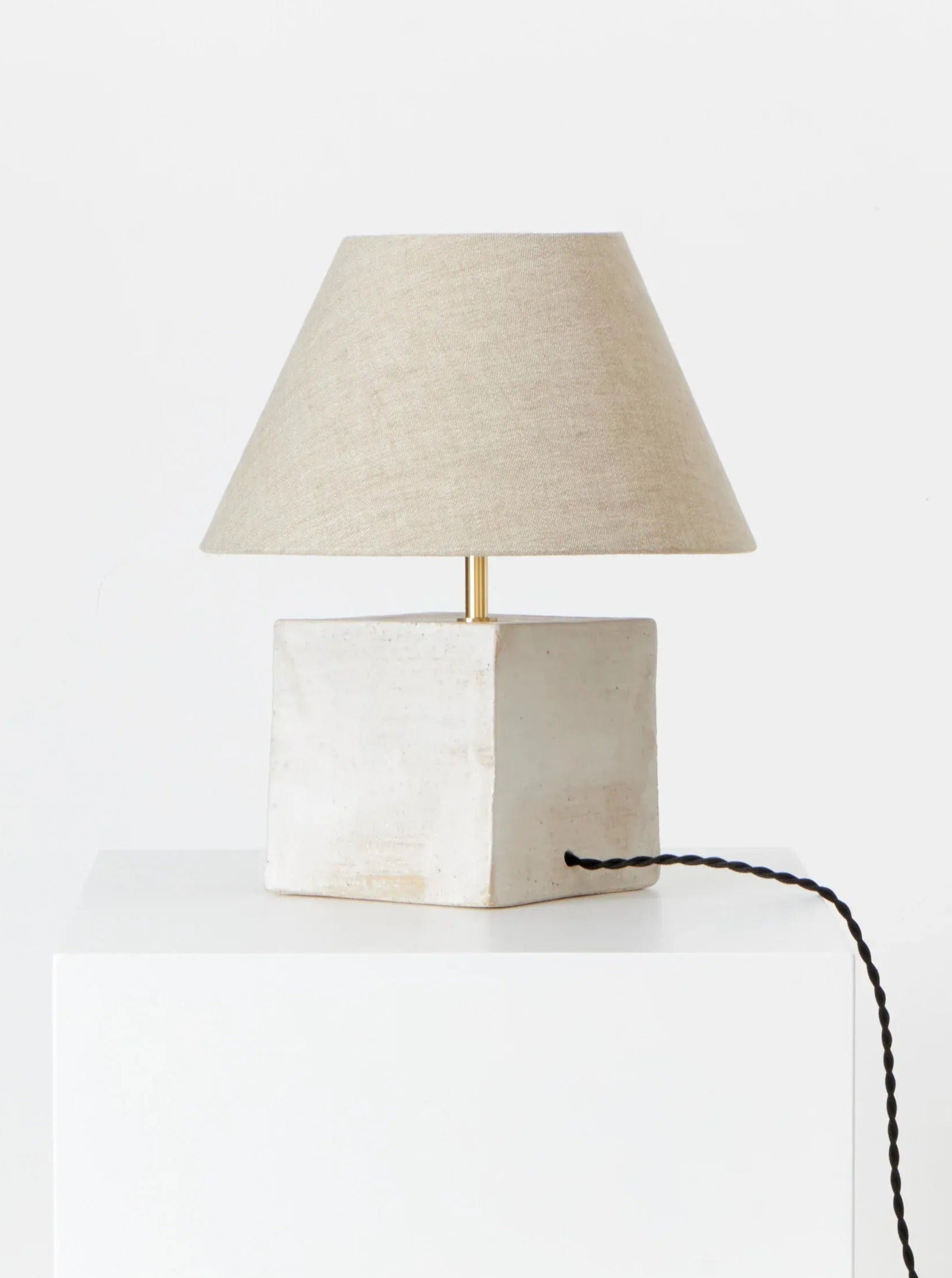 Arouca Table Light with modern design, brass finish, and adjustable arm for versatile illumination