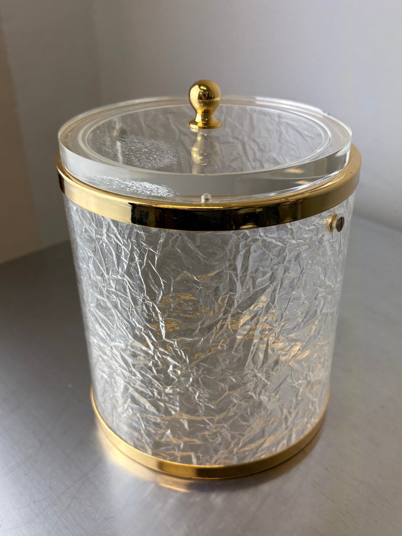 Clear lucite ice bucket with gold trim and textured surface detail