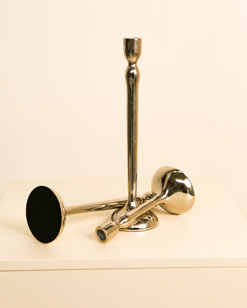 Golden brass triptych candleholders detail view showing geometric forms