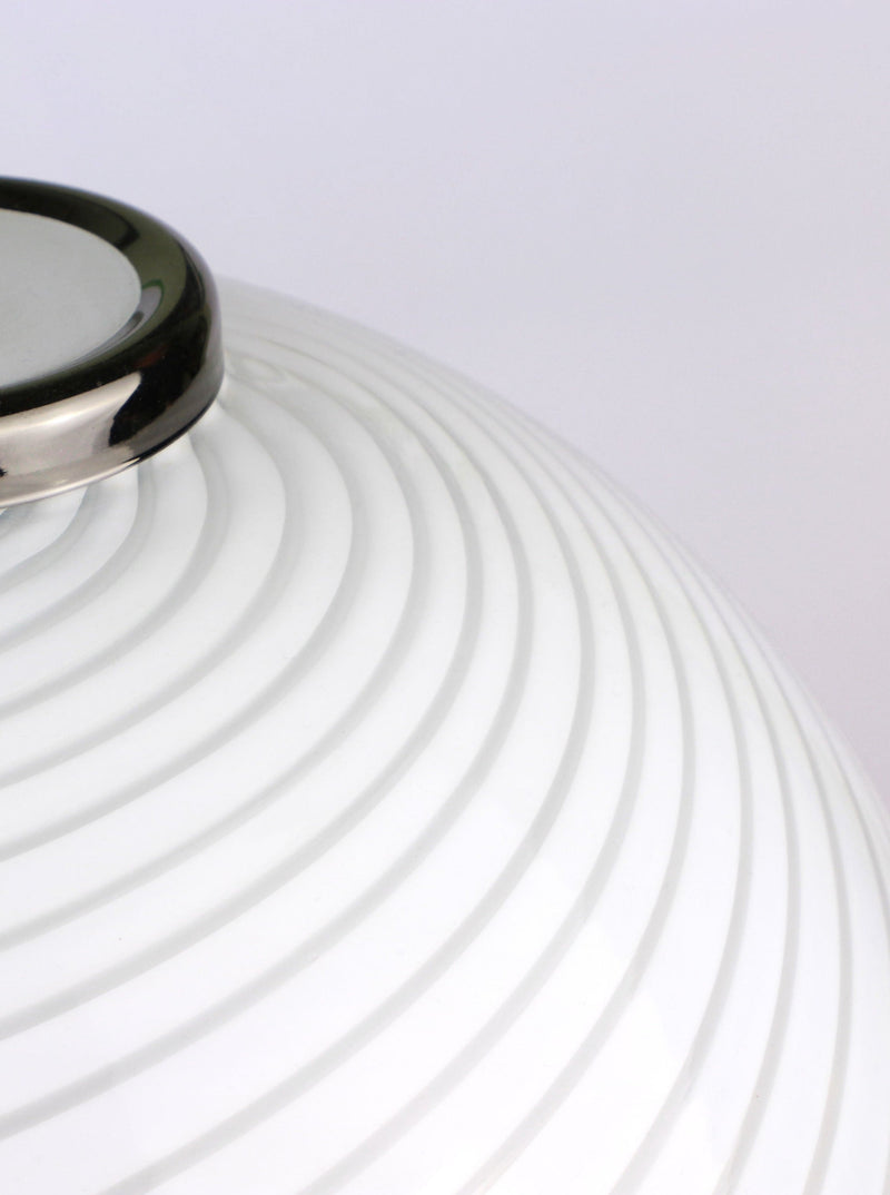 Close-up of a Murano Swirl Mushroom Table Lamp by F Fabbian for Mazzega (1980s), offered by Dodo Vintage, showing its white, round glass shade with metallic rim and raised spiral lines against a light background.