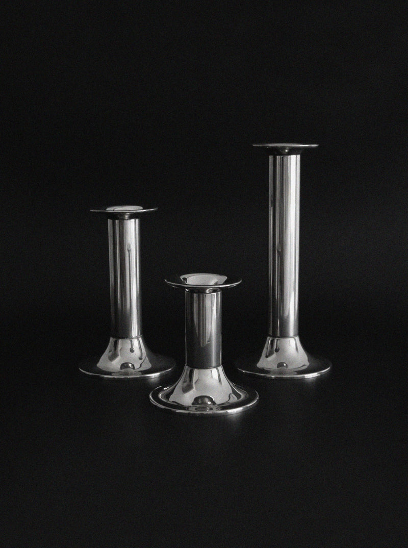 Three vintage silver plated candlesticks of varying heights