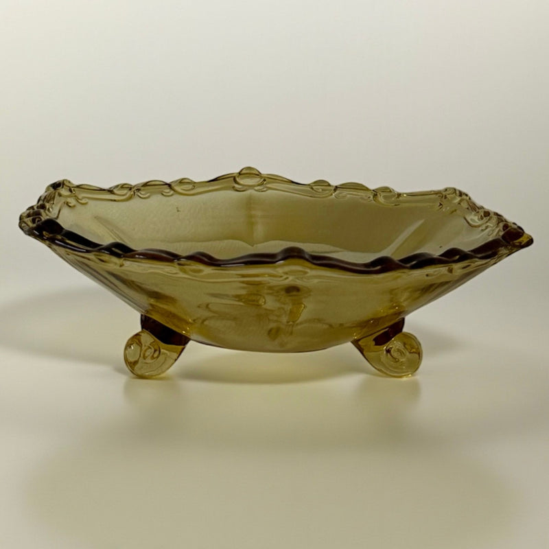 Art Deco amber glass bowl with scalloped rim and scrolled feet
