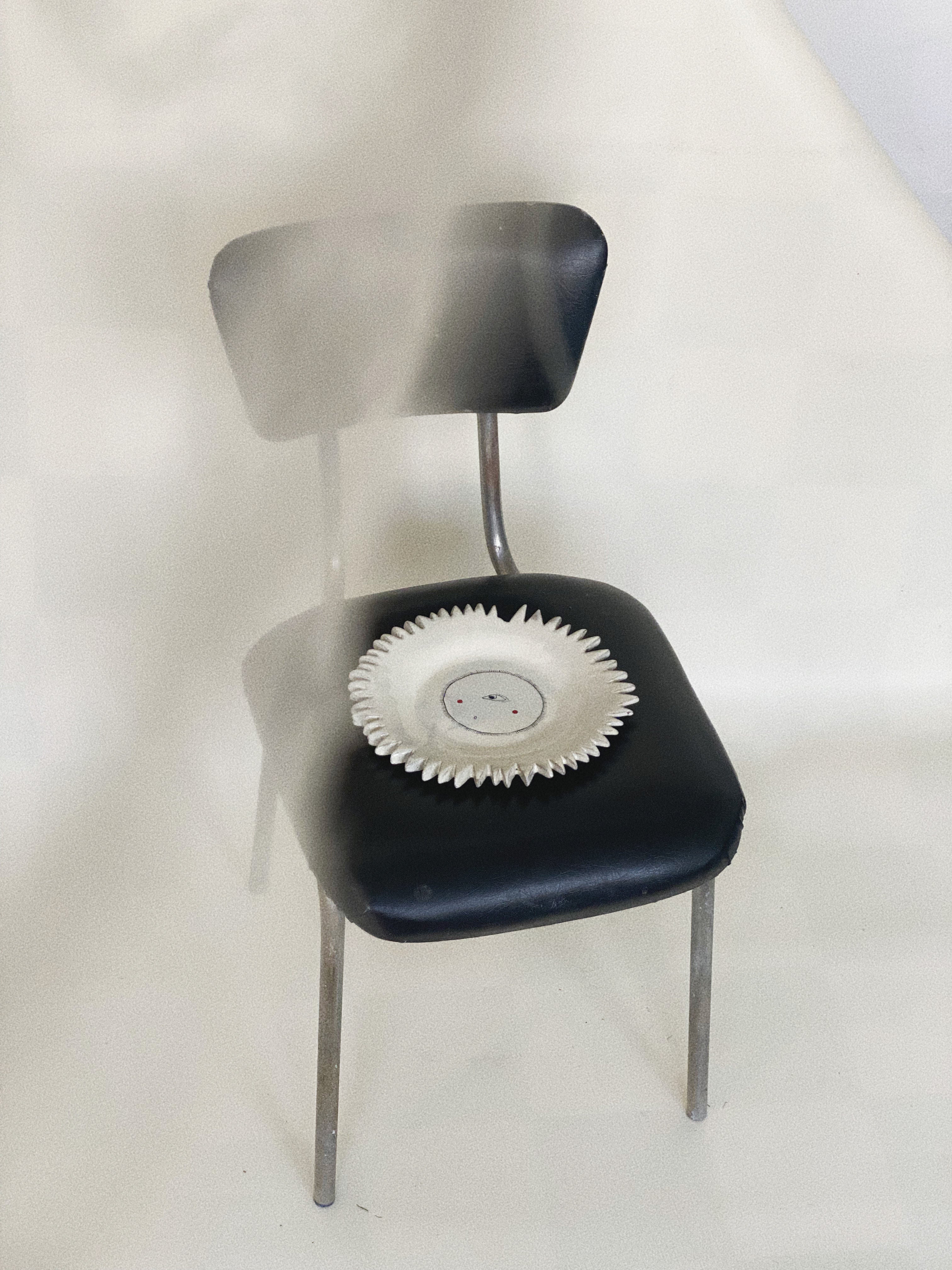 A close-up image of a golden Sun Plate, a circular dish with intricate sun-ray designs, perfect for serving meals outdoors on a sunny day