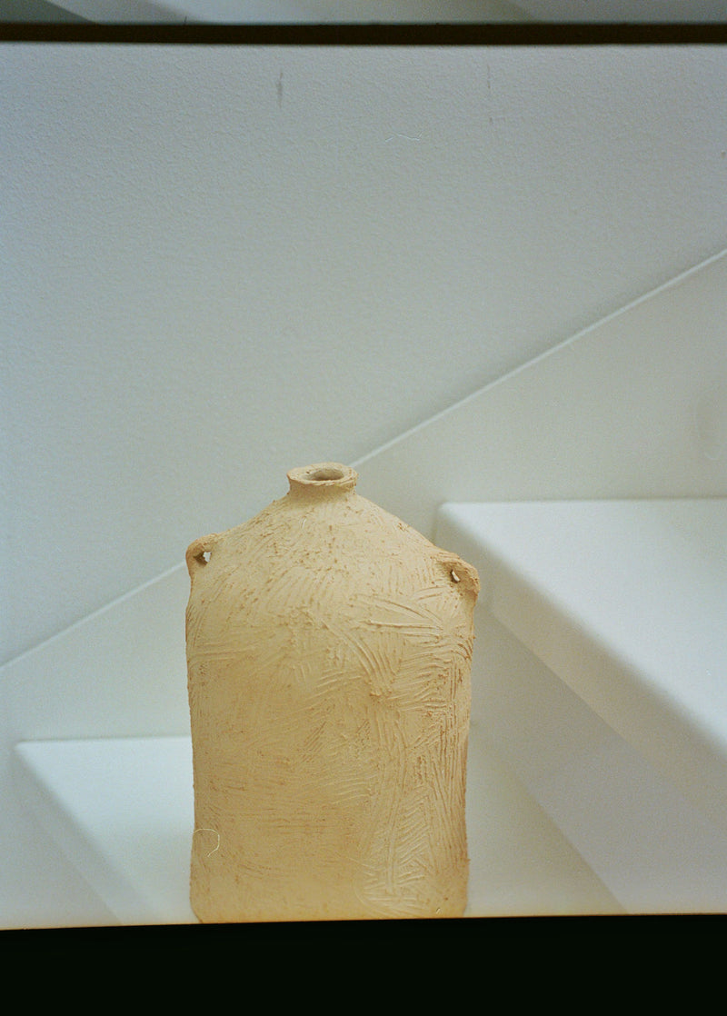 Textured ceramic vessel corner detail showing natural clay finish