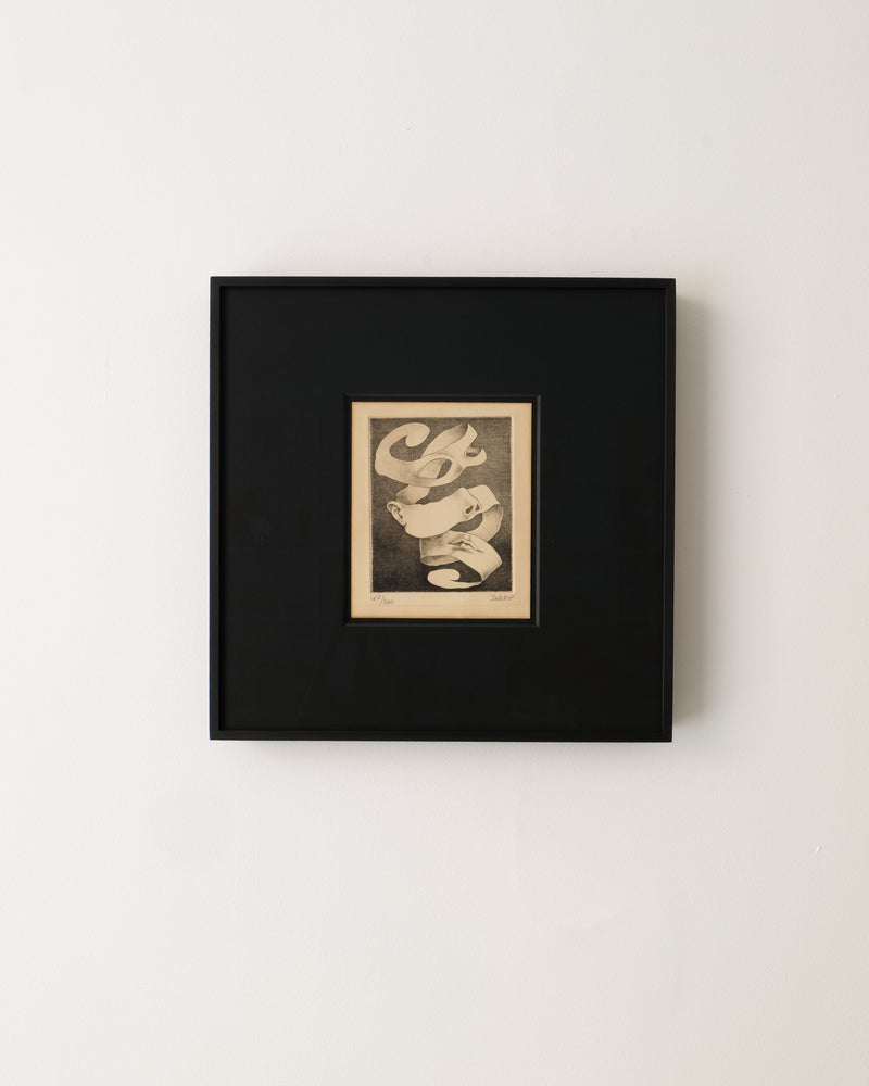 A Surrealist Engraving by Claude Serre (1938-1998) from Collection apart hangs on a white wall, showcasing abstract black-and-white swirling ribbons within a wide black mat and black frame.