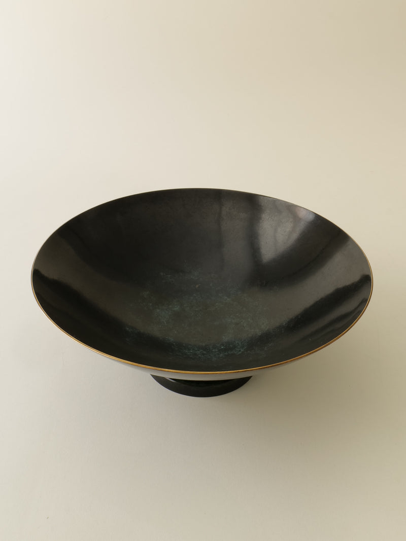 Dark patinated bronze bowl profile view showing curved form