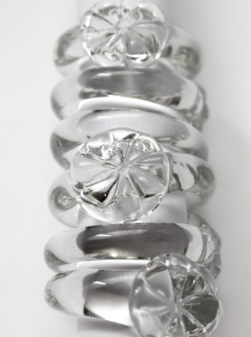 Set of vintage clear glass napkin rings with floral motifs