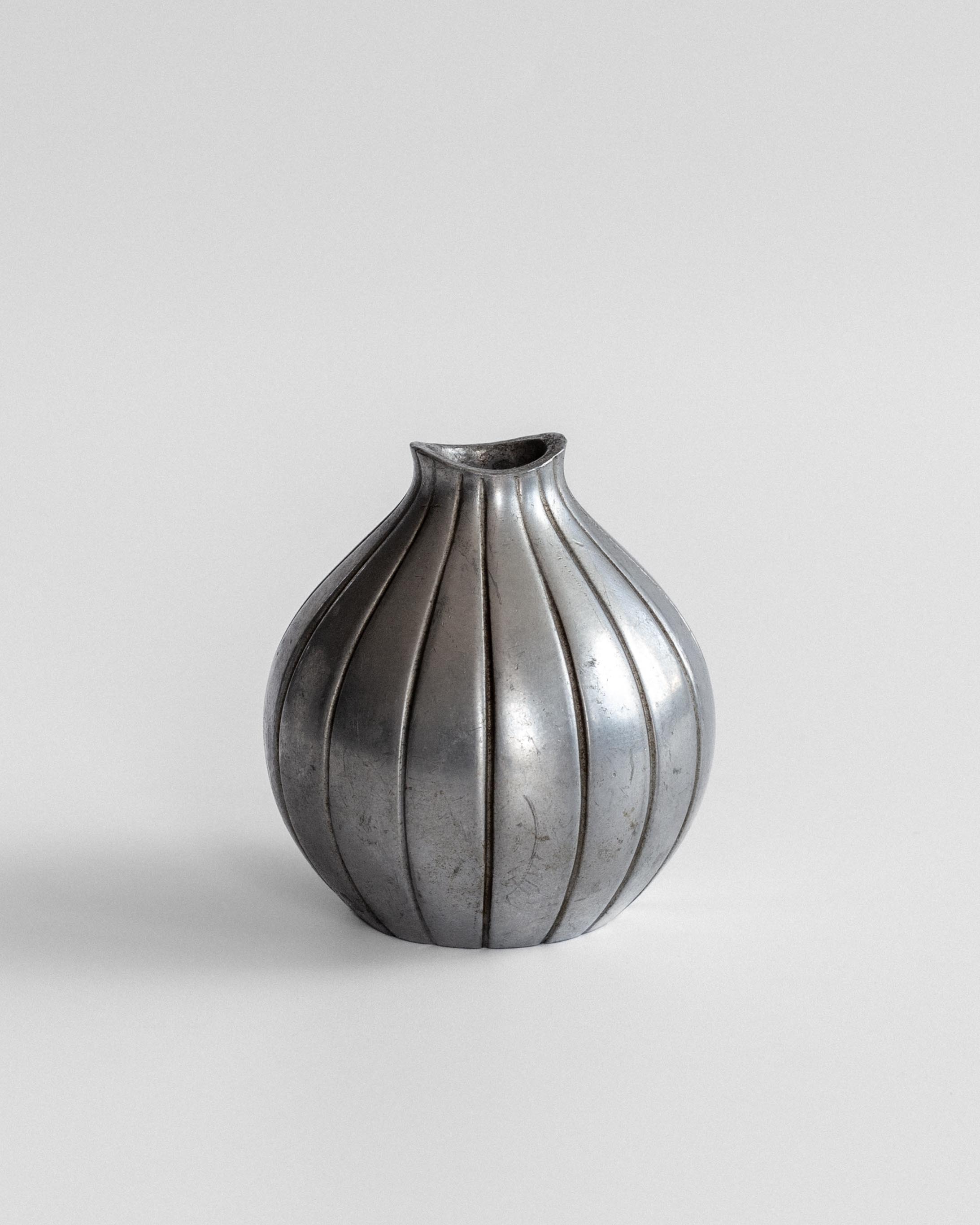 Ribbed pewter vase profile showing vertical fluted design detail