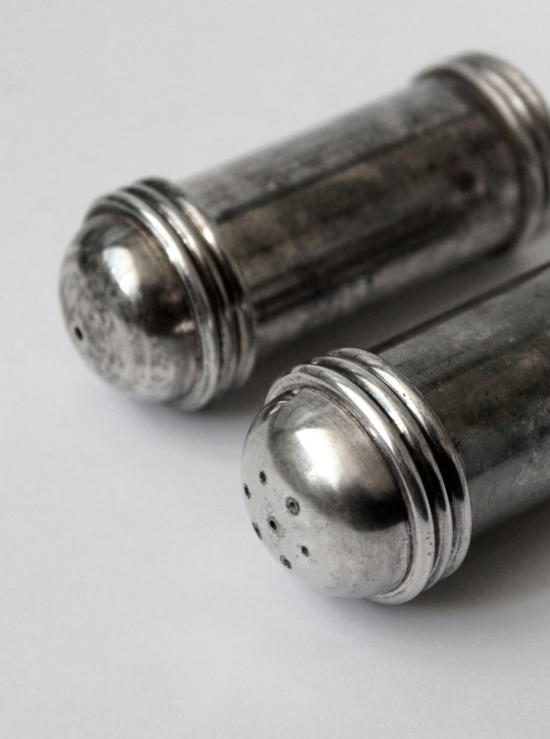 Silver plated salt pepper shakers close-up detail view