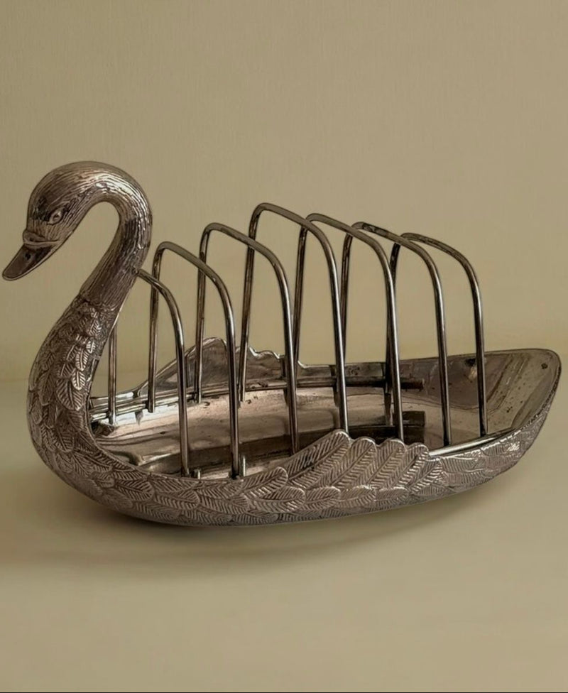 Silver swan-shaped toast rack with feathered detailing and vertical slots