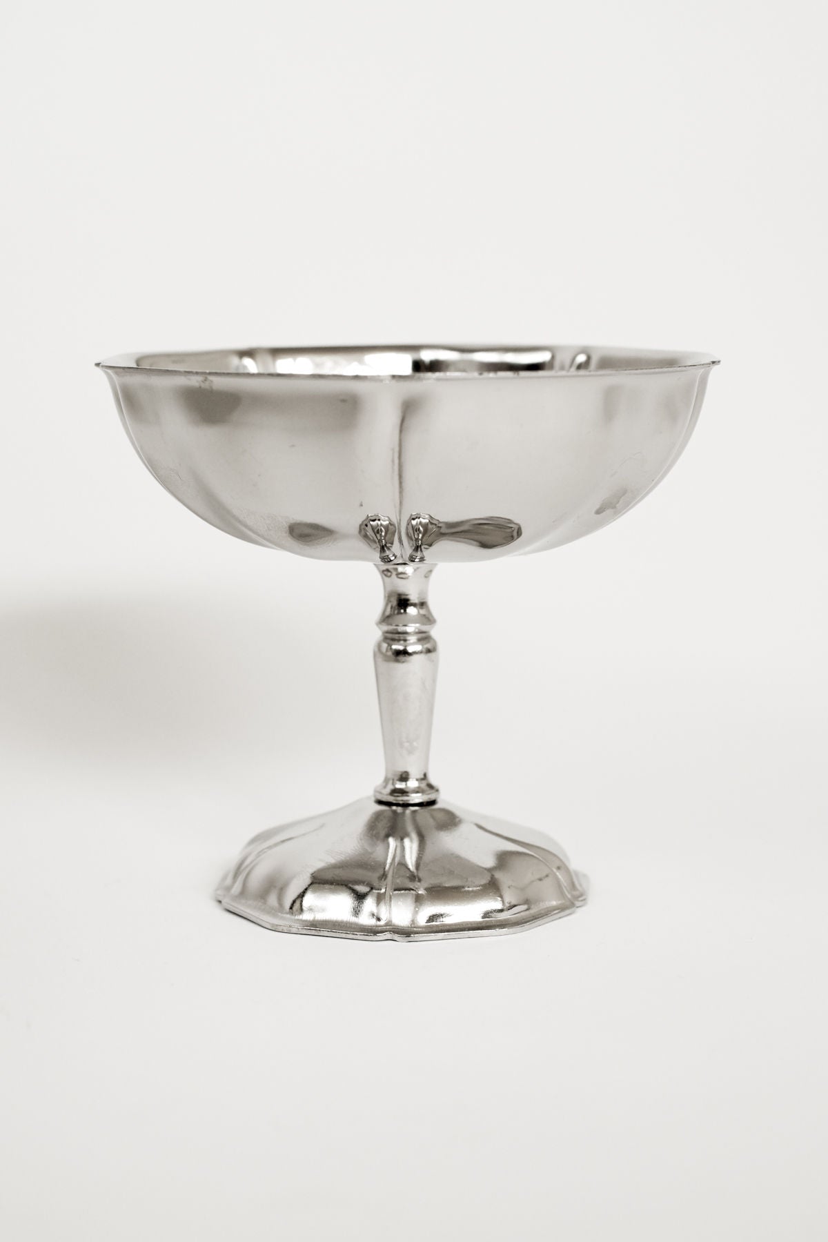 The Set of Six Ice Coupes by septembre studios features silver, shallow, wide-bowled goblets with short stems and round bases, offering vintage appeal against a plain white background.