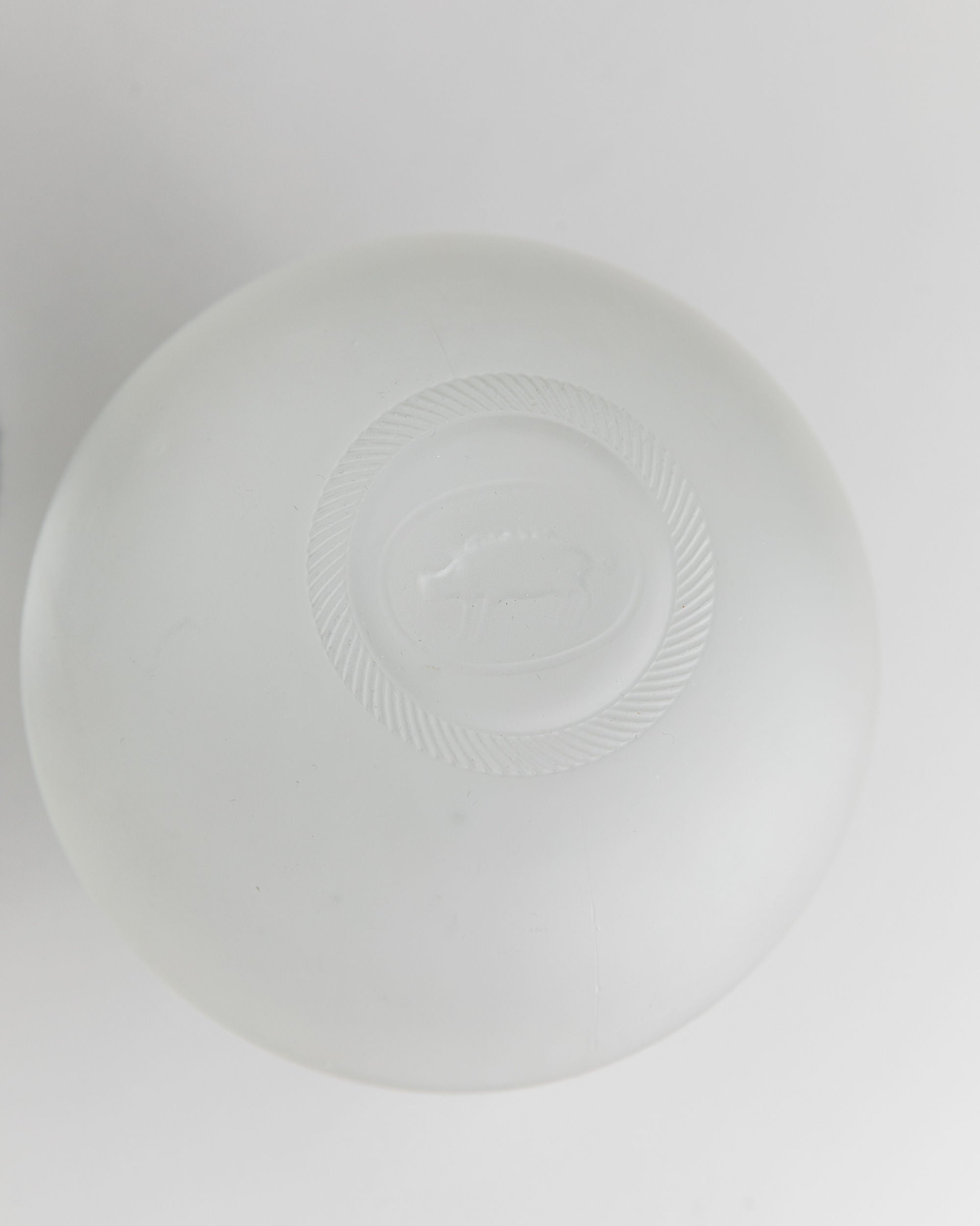 A round bar of translucent soap, named "Liqueur Bottle, Italy 1980s," by Bottega Jacobs, features an embossed sheep design at the center. Set against a plain white background, it highlights the soap's smooth texture and circular shape.