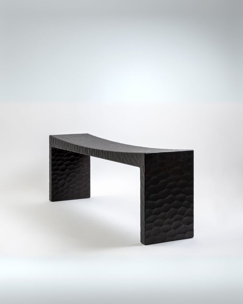 Black carved wooden bench with honeycomb textured sides by Rivadossi