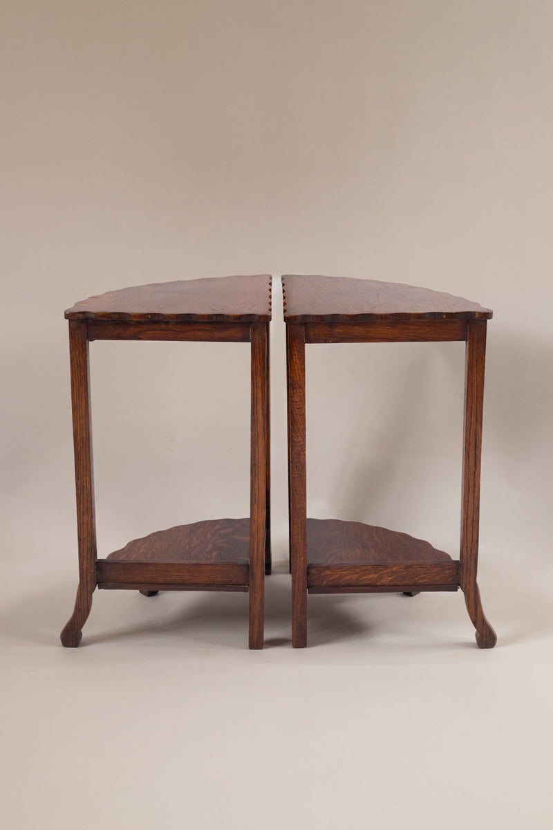 Two vintage wooden side tables positioned together showing curved legs and lower shelf detail