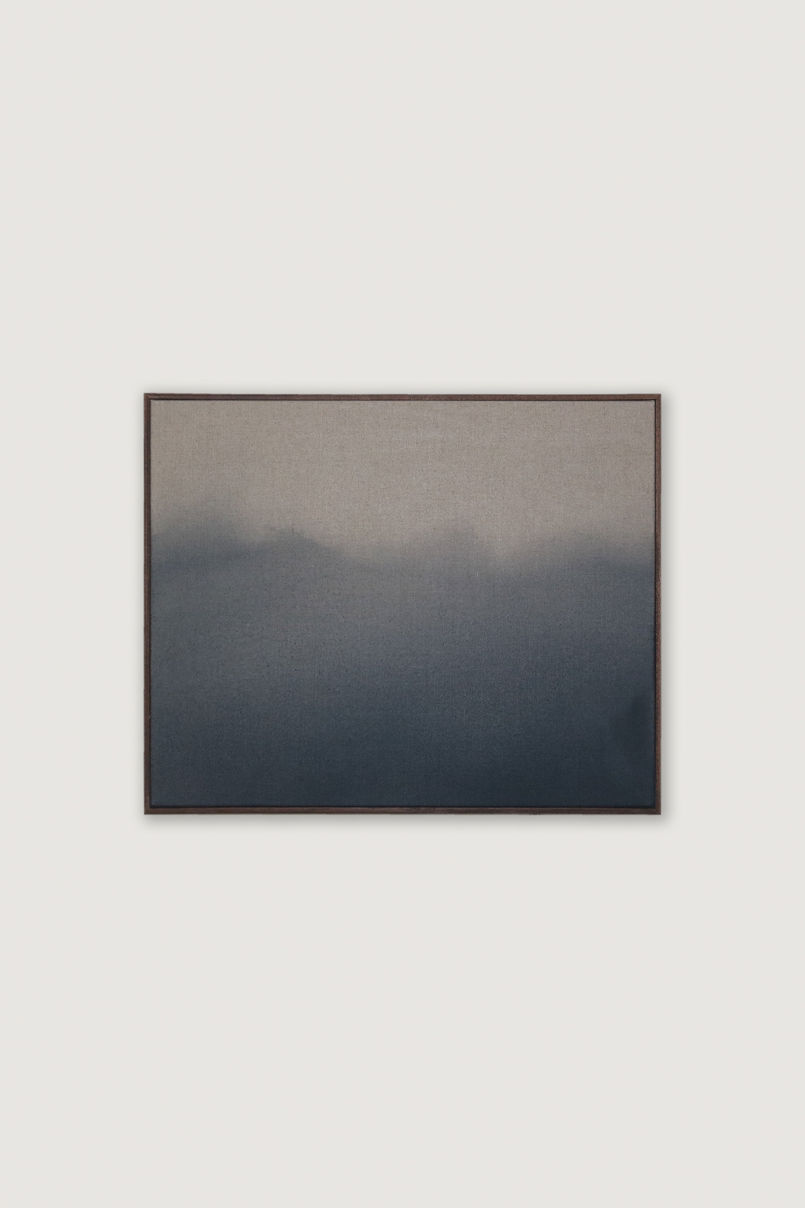 The "Wild Silence" painting by David Hardy is an original acrylic on linen piece that features a gradient of dark grey to light grey, reminiscent of fog or mist. The colors smoothly transition from the darkest shade at the bottom to the lightest at the top, creating a serene and minimalist effect against a plain white background.