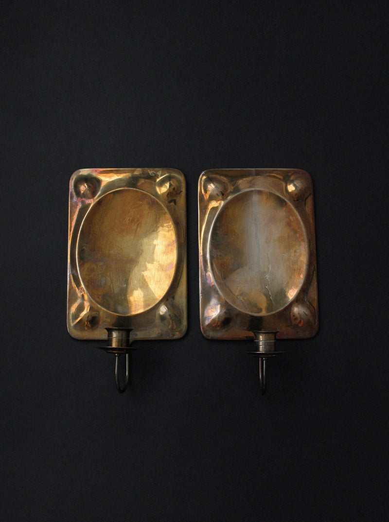 Pair of vintage brass wall sconces with oval reflector detail