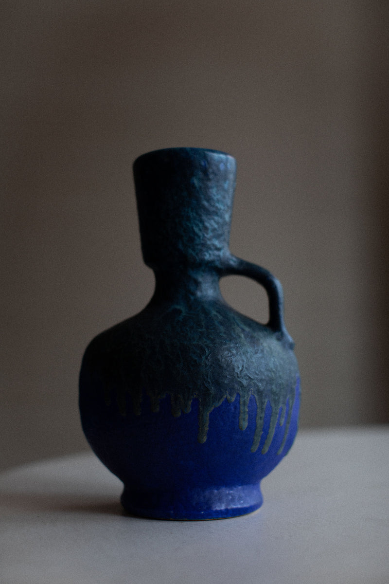 A beautifully crafted vintage vase with intricate floral designs and a rustic finish