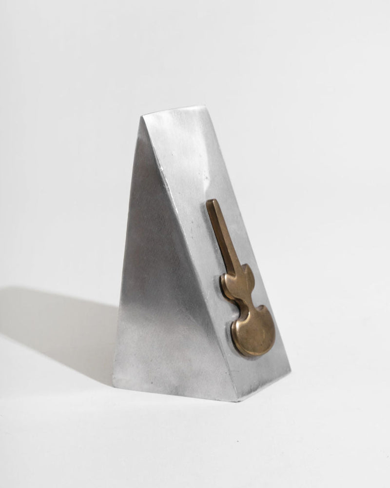 White marble triangular bookend with brass key detail view
