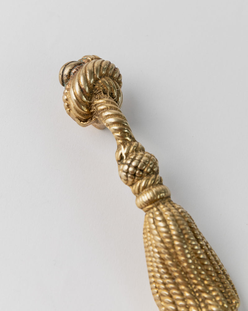 Twisted brass bottle opener handle detail showing ribbed texture