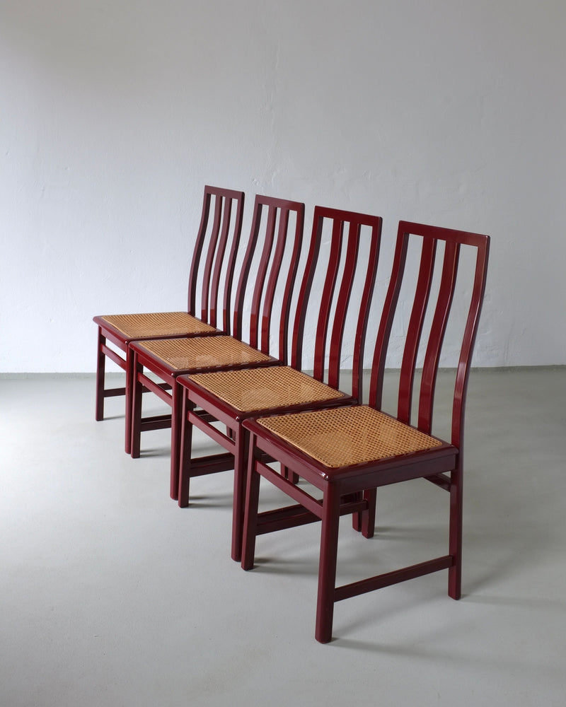 Four glossy wine red dining chairs with woven cane seats Italy 1970s