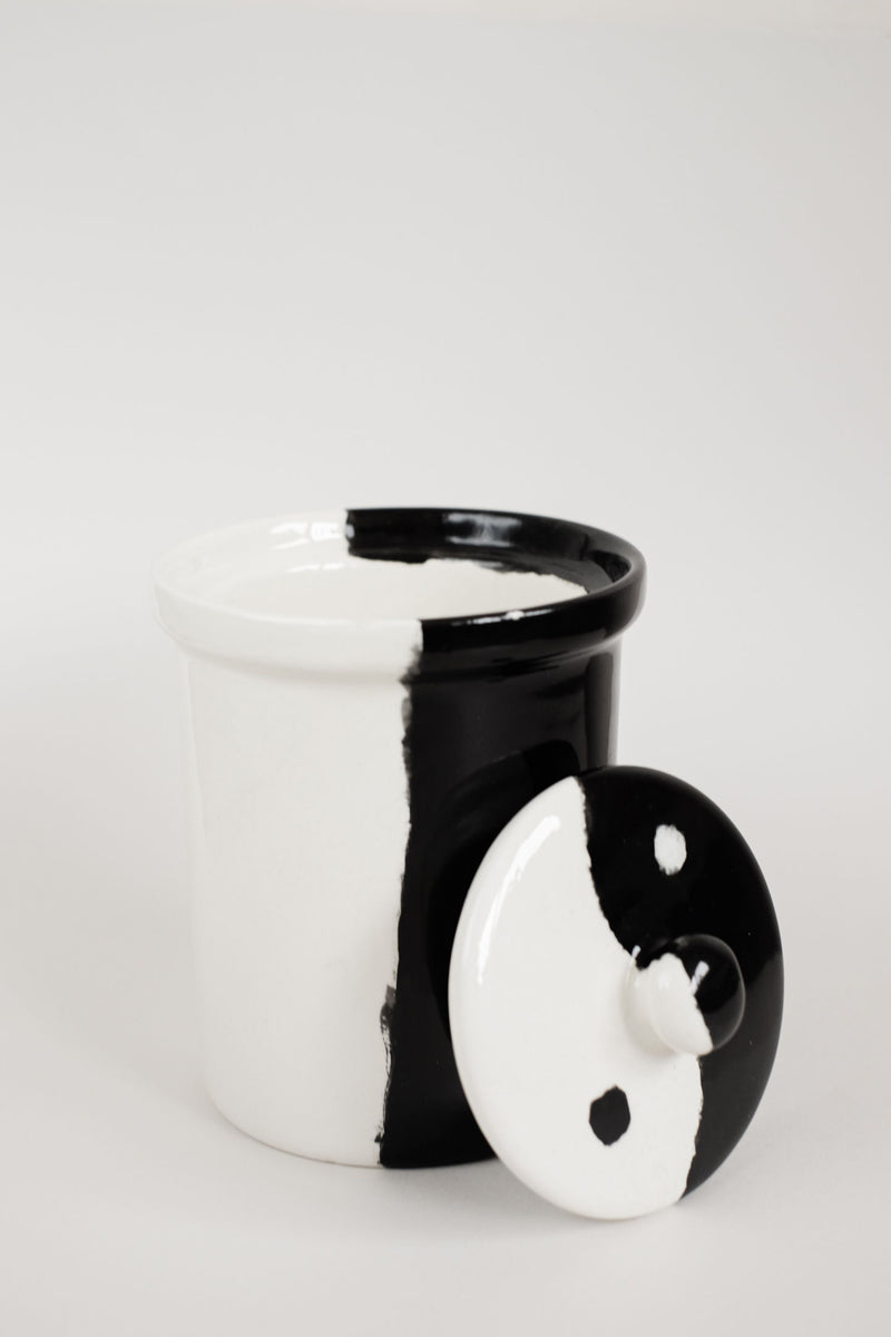 Black and white ceramic jar with yin-yang design detail view