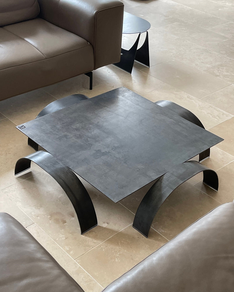 YUMI low coffee table with curved black metal legs and concrete top