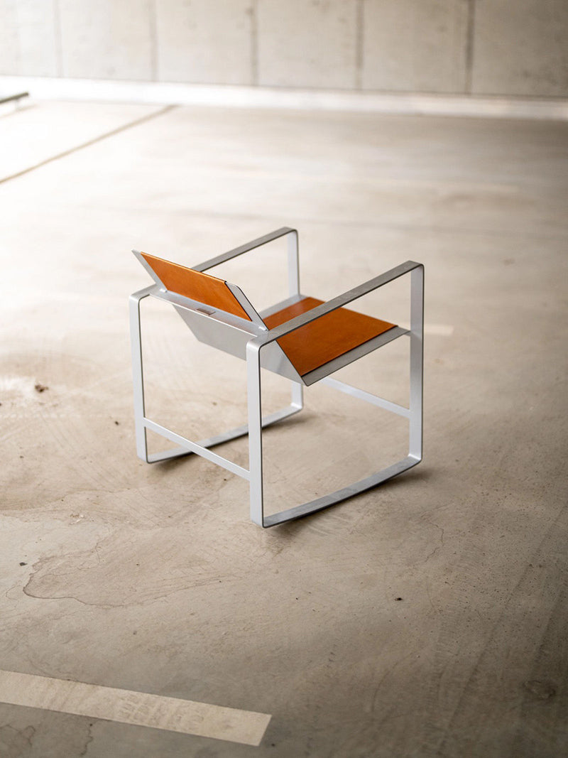 Modern stainless steel rocking chair with orange leather seat
