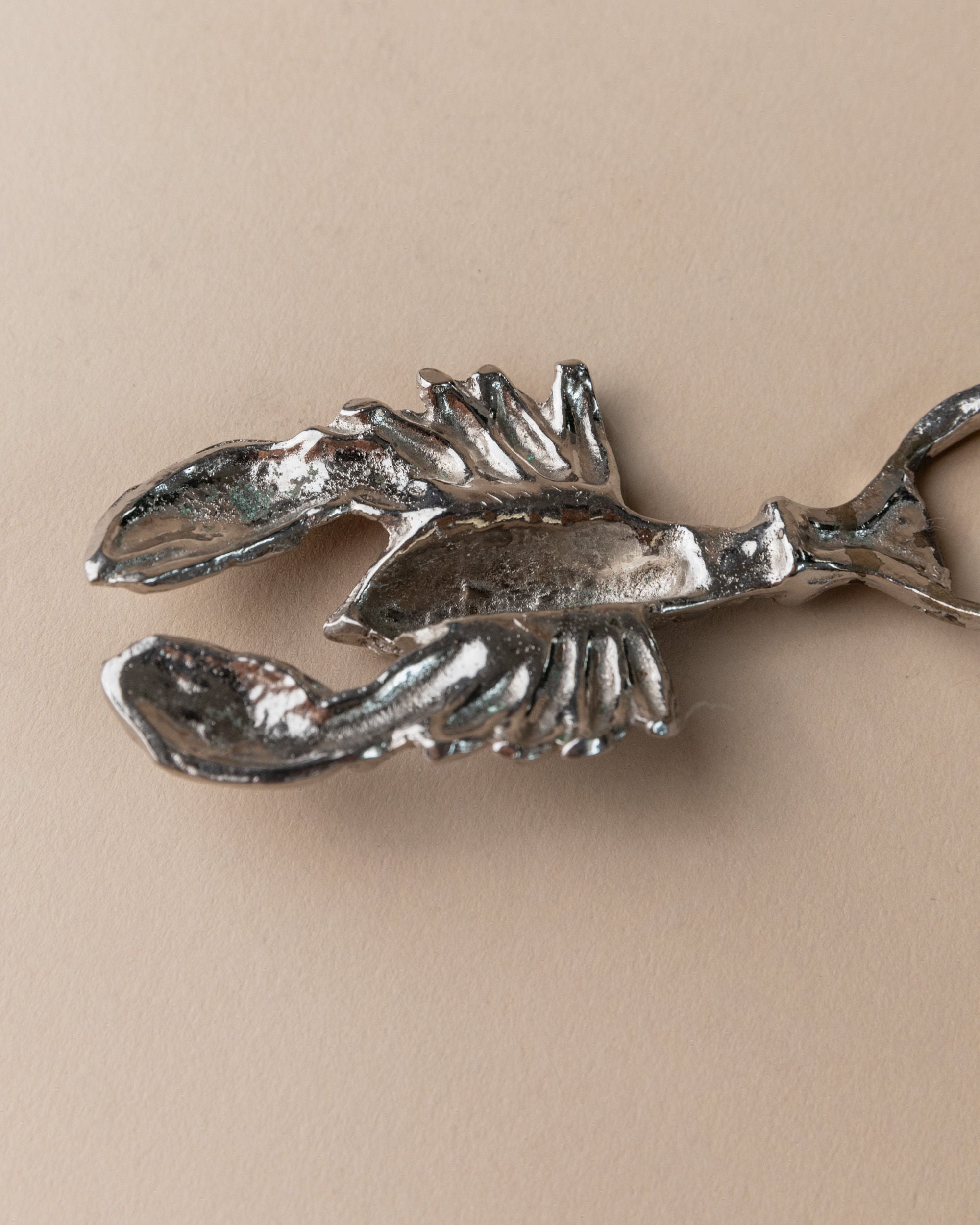 Silver plated lobster-shaped bottle opener detail view, Italy 1960s