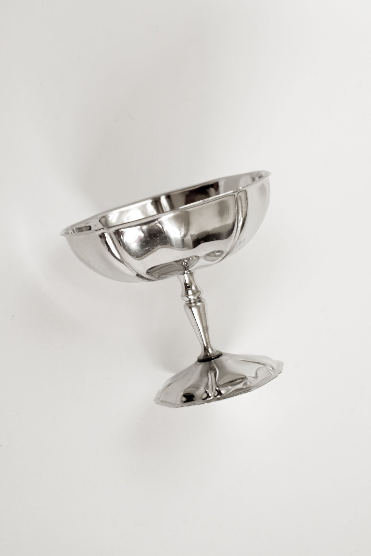A set of five stainless steel Ice Coupes by septembre studios, featuring vintage appeal, is displayed lying on its side against a plain white background.