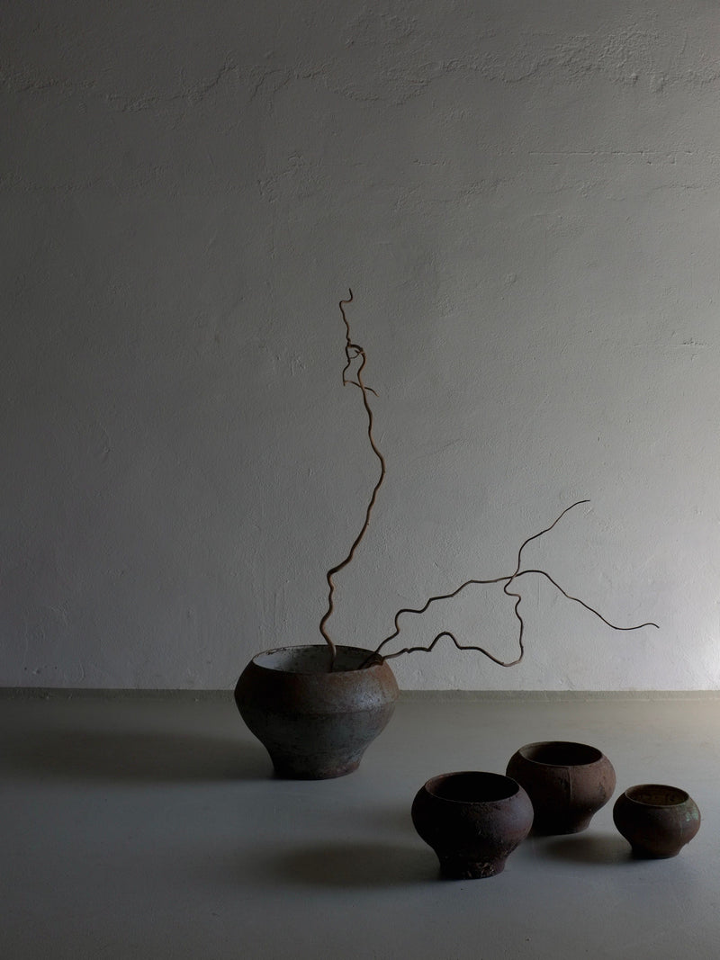 Set of four vintage wabi sabi iron cooking pots with curly branches