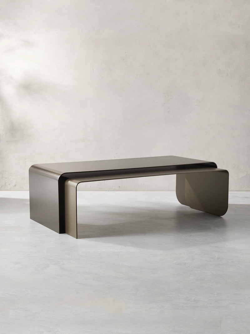 Modern metal coffee table with curved rectangular design by ATELIER26