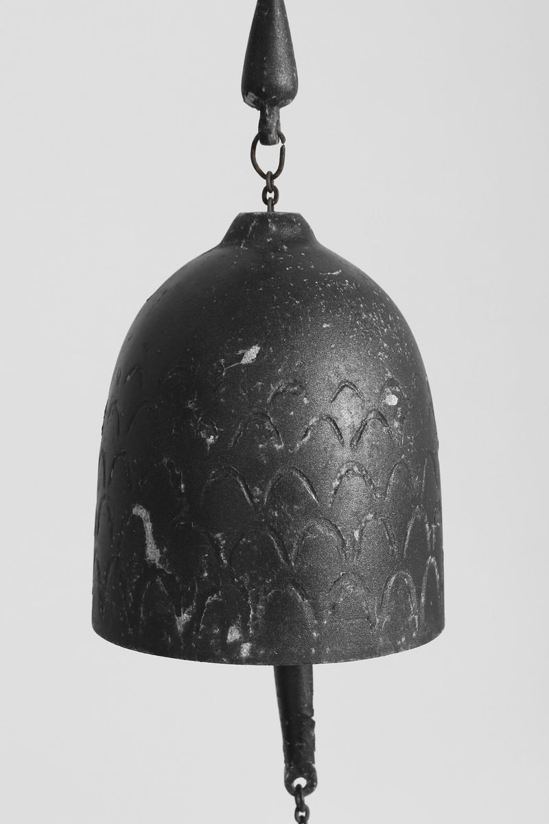 Handcrafted iron windbell with floral relief pattern detail