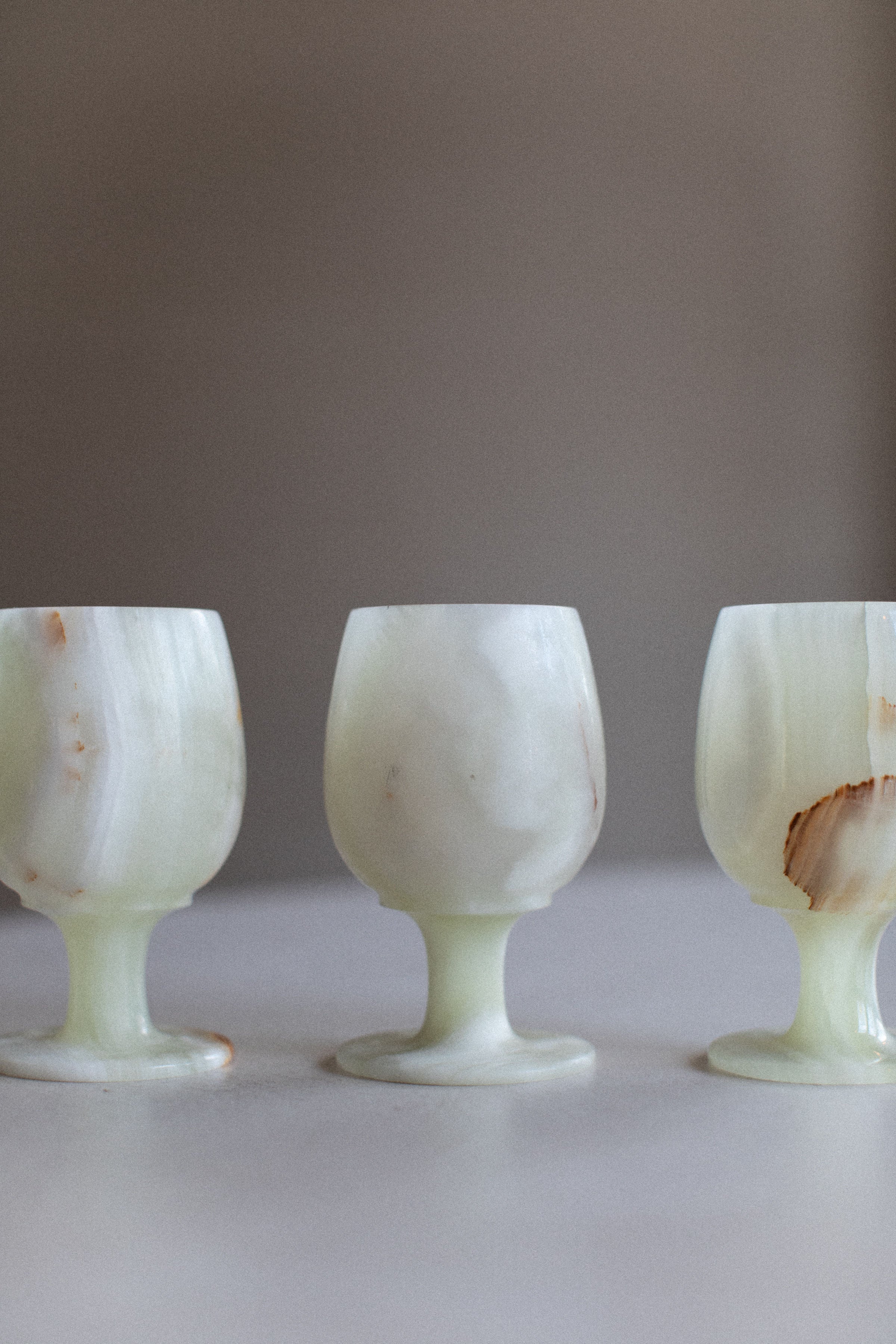 A set of 4 elegant marble cups with matching saucers