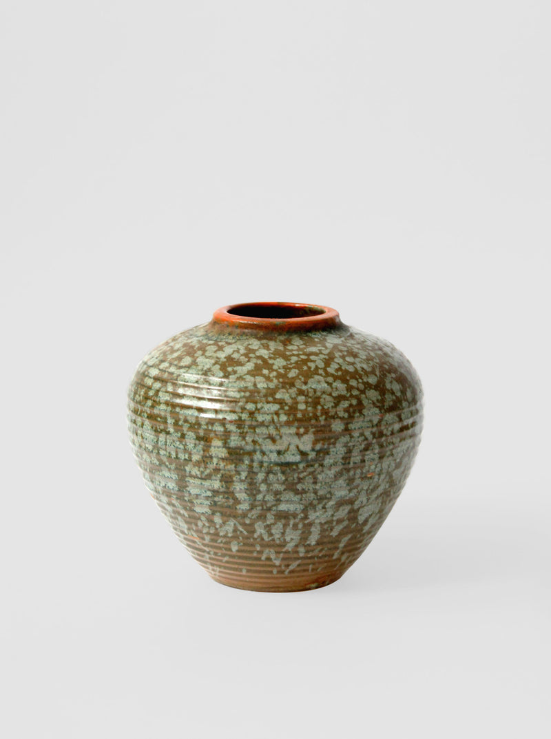 Small vintage ceramic vase with green speckled glaze and orange rim