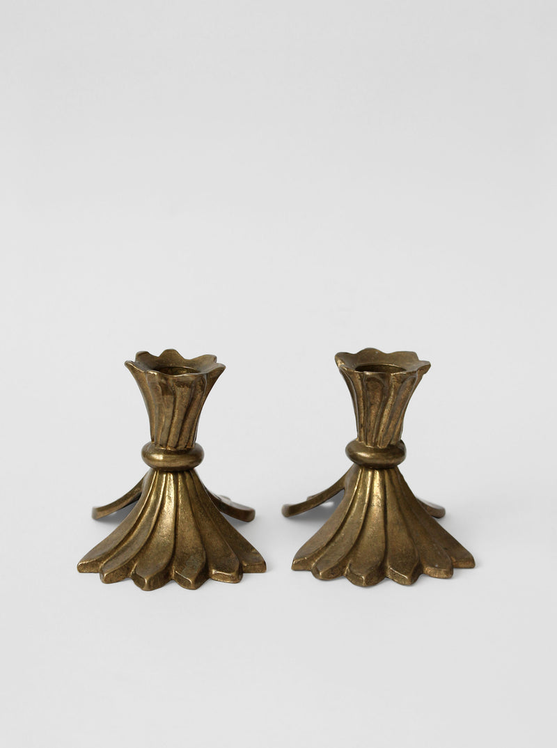 Pair of elegant brass candle holders with fluted design