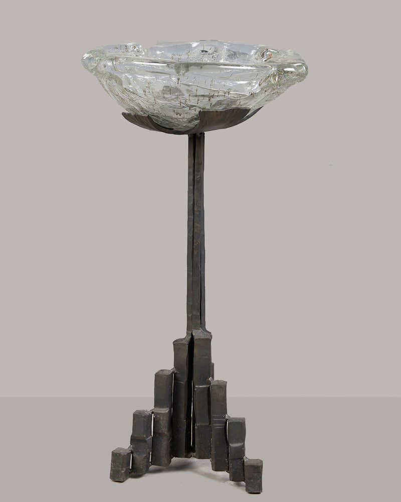 Brutalist iron candle stand with geometric base and glass bowl