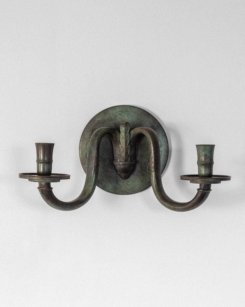 Art Deco bronze wall sconce with curved arms and candle holders