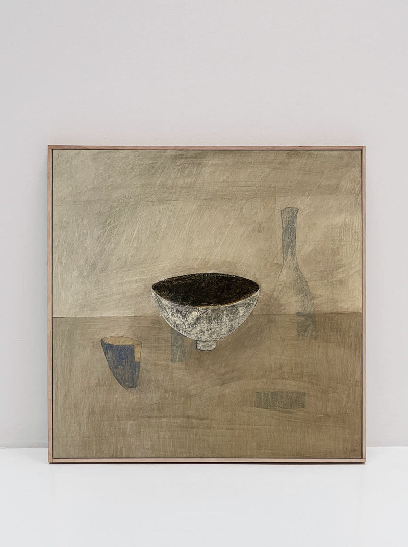 A framed, original still life painting on cradled wooden panel depicts a minimalistic scene. In the center, there's a textured bowl, with a faint, abstractly shaded bottle and cup in the background. The muted and earthy color palette features shades of brown, gray, and beige. The 'Ansoku' Painting by Lara Voce captures this serene composition beautifully.