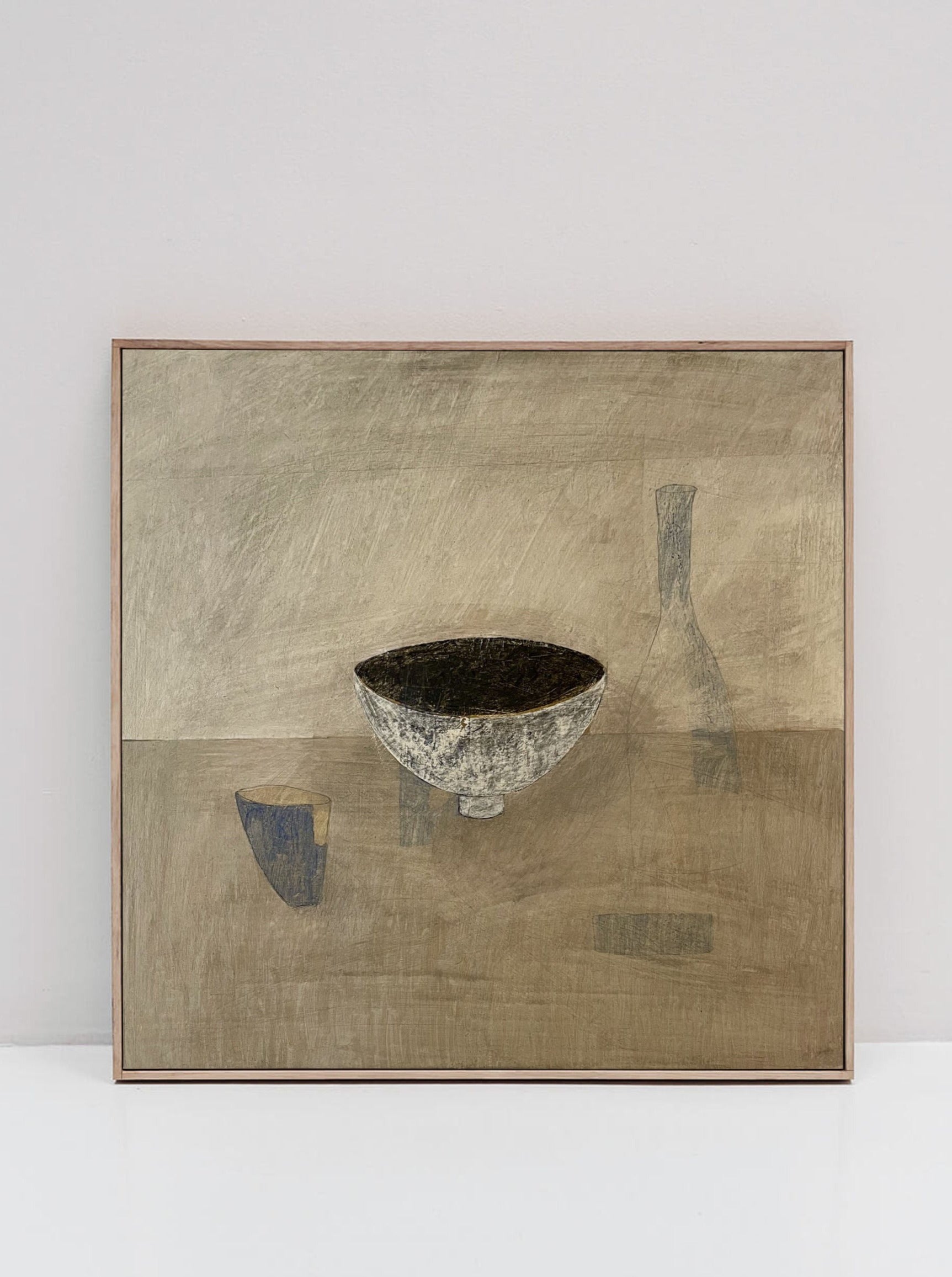 A framed, original still life painting on cradled wooden panel depicts a minimalistic scene. In the center, there's a textured bowl, with a faint, abstractly shaded bottle and cup in the background. The muted and earthy color palette features shades of brown, gray, and beige. The 'Ansoku' Painting by Lara Voce captures this serene composition beautifully.