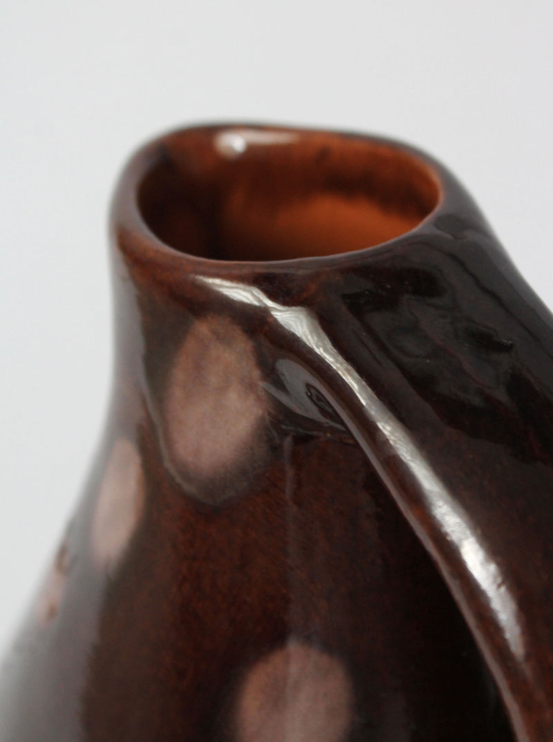Close-up detail of vintage ceramic jug handle and spout profile
