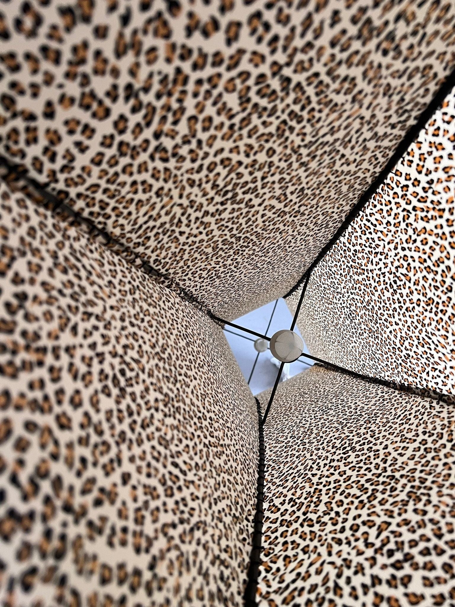 Looking up from beneath the Veter Vintage Leopard Print Floor Lamp (1980s), you see the central pole and a hint of blue sky through its distinctive animal print fabric panels.
