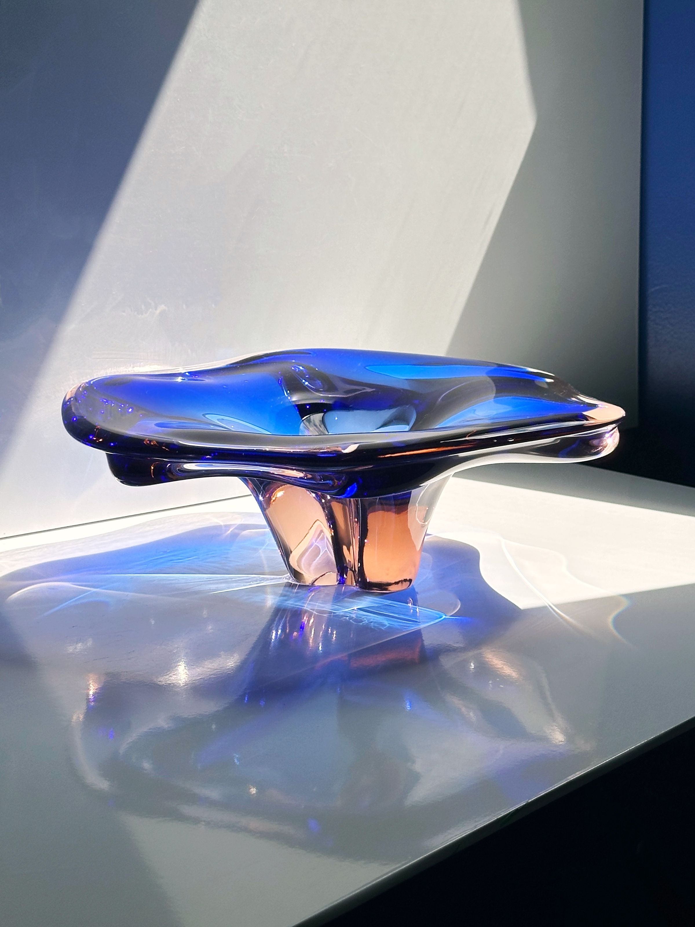 Large Bohemian glass bowl with blue accents reflecting light