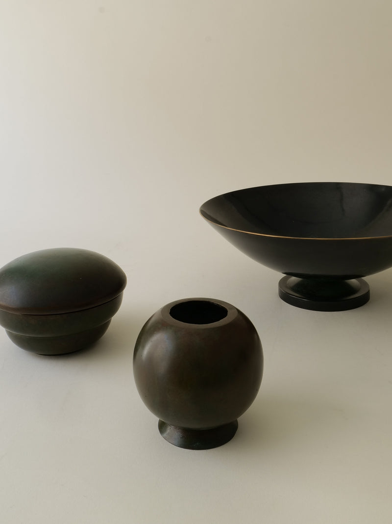 Dark bronze vases collection showing three different vessel forms