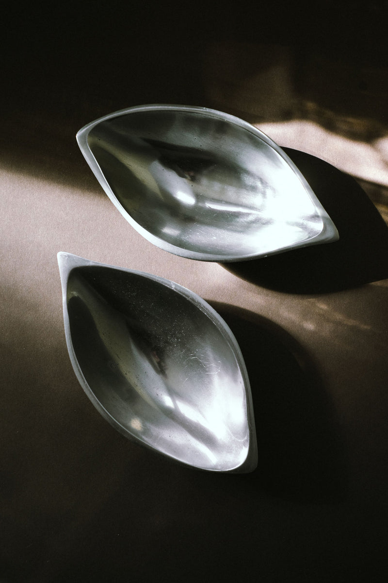 Two translucent glass serving dishes with organic curved shapes