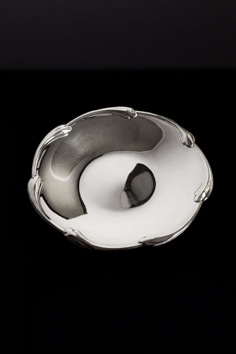 Large silver-plated decorative dish with ornate scalloped rim