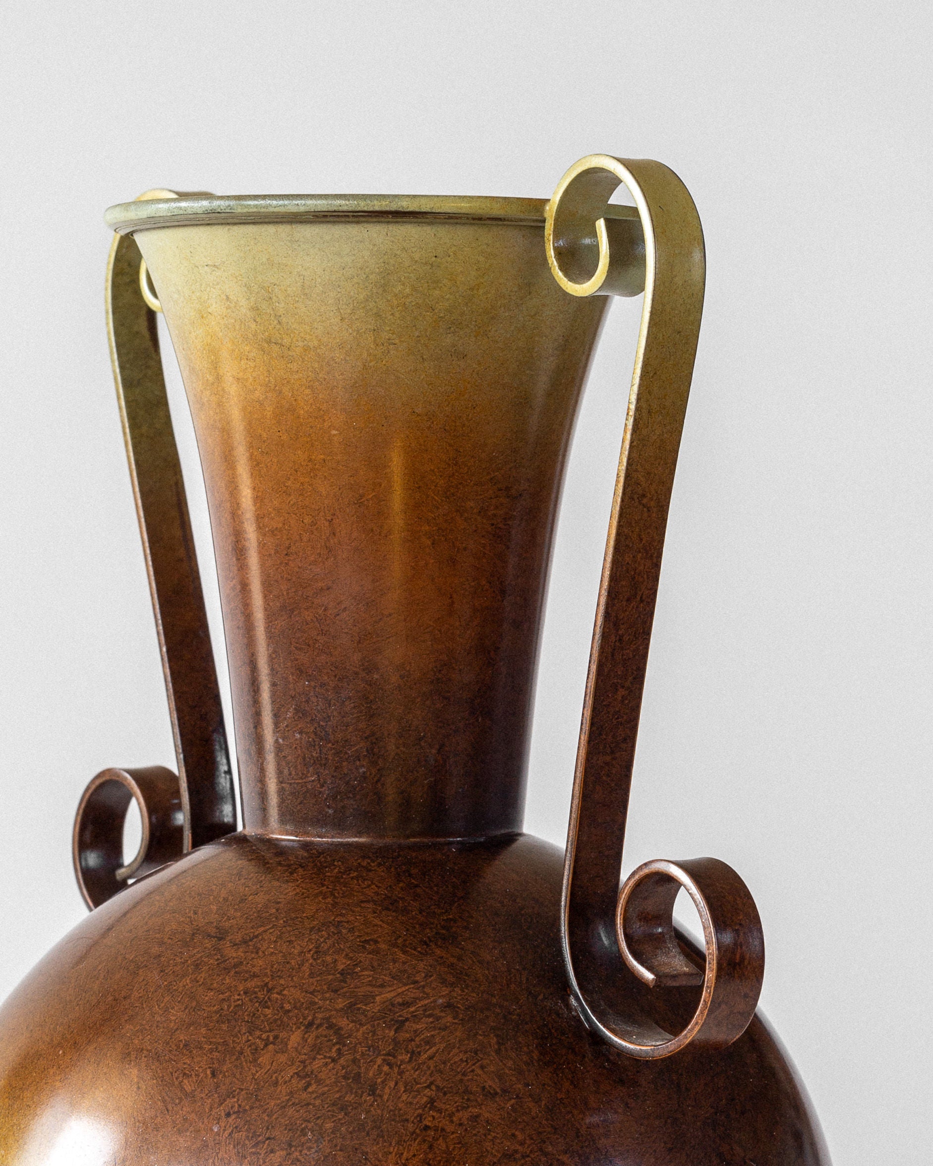 Close-up of a Spigel Swedish Art Deco Bronze Vase from the 1930s, featuring elegant spiral handles and a flared gradient top. The rich patina enhances its craftsmanship, emblematic of Scandinavian Art Deco, against a plain light gray background.