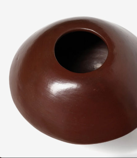 The ZAROLAT 'Ovni' Vase is a handmade, round ceramic pot with a smooth reddish-brown finish and wide opening, displayed against a white background.